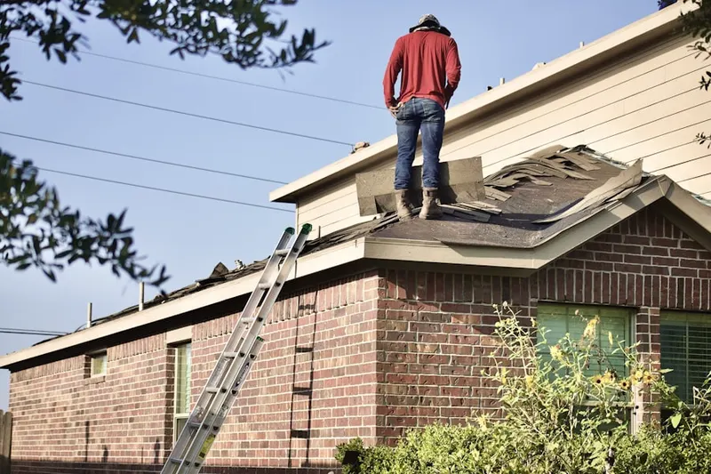 Professional roofer working on a residential roof in Floresville